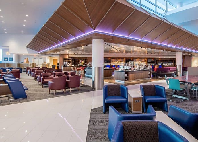 Interior of an airport lounge with modern seating and ambient lighting.